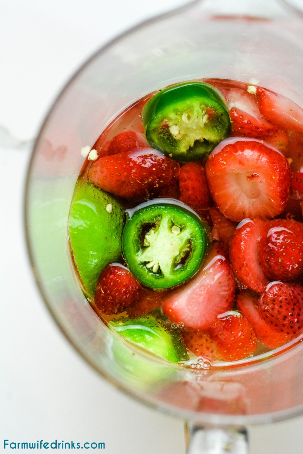 Champagne margaritas are sweet and spicy with the combination of a bottle of bubbly, sugared strawberries, Cointreau, lime juice, and jalapenos.