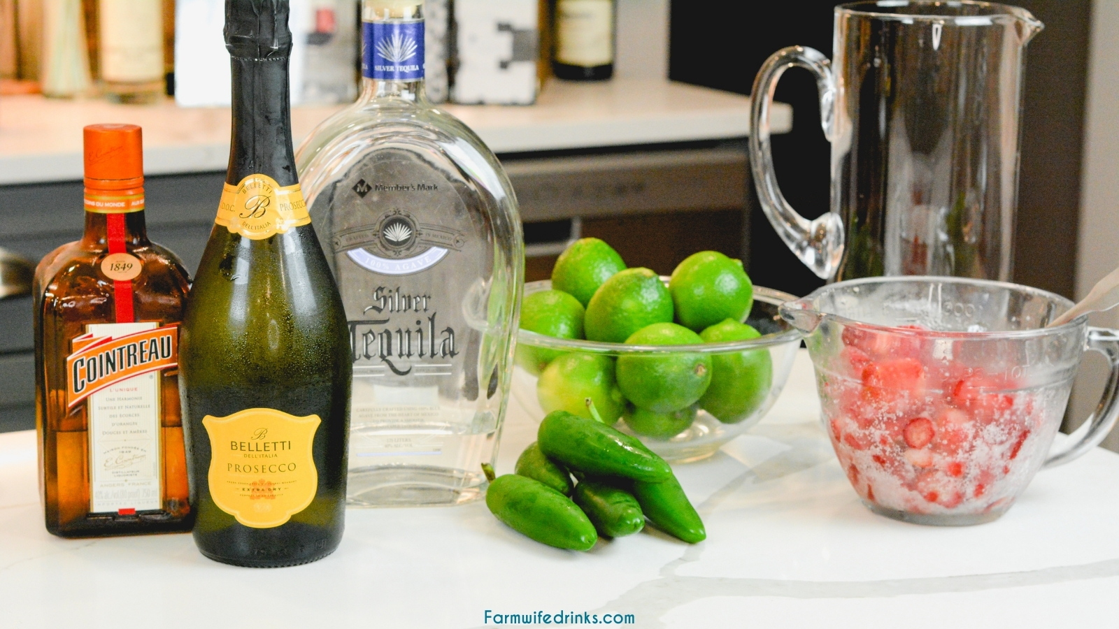 Champagne Margarita Ingredients - Tequila, champagne, cointreau, strawberries, limes, and jalapeños.