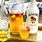 Malibu sangria recipe is a simple and perfect tropical drink for a summer day pool cocktail made with white wine, Malibu Rum, pineapple juice, and tropical frozen fruit like pineapple and mangos.