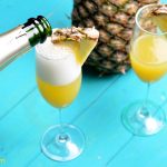 Start a weekend morning with the flavors of Hawaiian with these Hawaiian Pineapple Mimosa made with pineapple juice and champagne. #Champagne #Mimosas #Pineapple