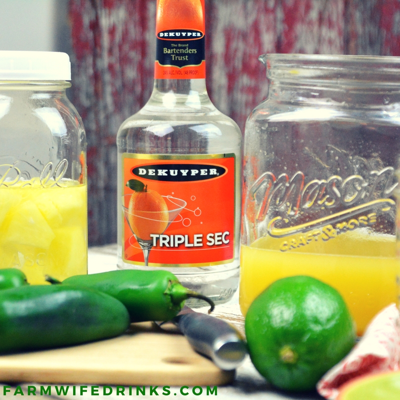 Spicy Pineapple Margaritas by the Pitcher combine the sweet nectar of pineapple infused tequila with triple sec, pineapple and lime juices and a kick of jalapeno heat. Add Tajin seasoning to add a smoky heat to the salted rim.