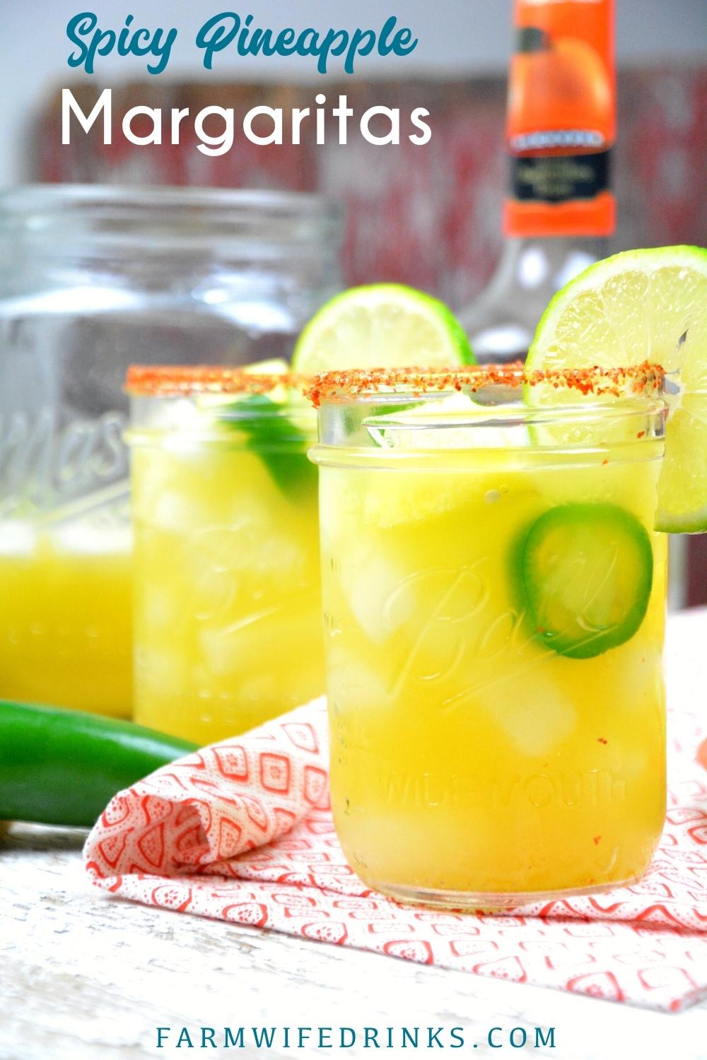 Spicy Pineapple Margaritas are an easy pineapple jalapeno margarita made with silver tequila, triple sec, pineapple and lime juices, and jalapenos with Tajin seasoning rimmed glass.