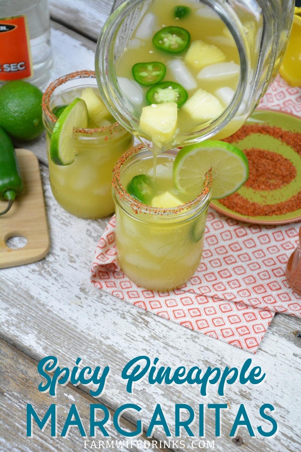 Spicy Pineapple Margaritas are an easy pineapple jalapeno margarita made with silver tequila, triple sec, pineapple and lime juices, and jalapenos with Tajin seasoning rimmed glass.