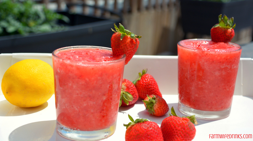 Strawberry Pink Lemonade Slushies combine frozen strawberries with pink lemonade to make a great, refreshing frozen mocktail for the kids and adults to enjoy all day long.