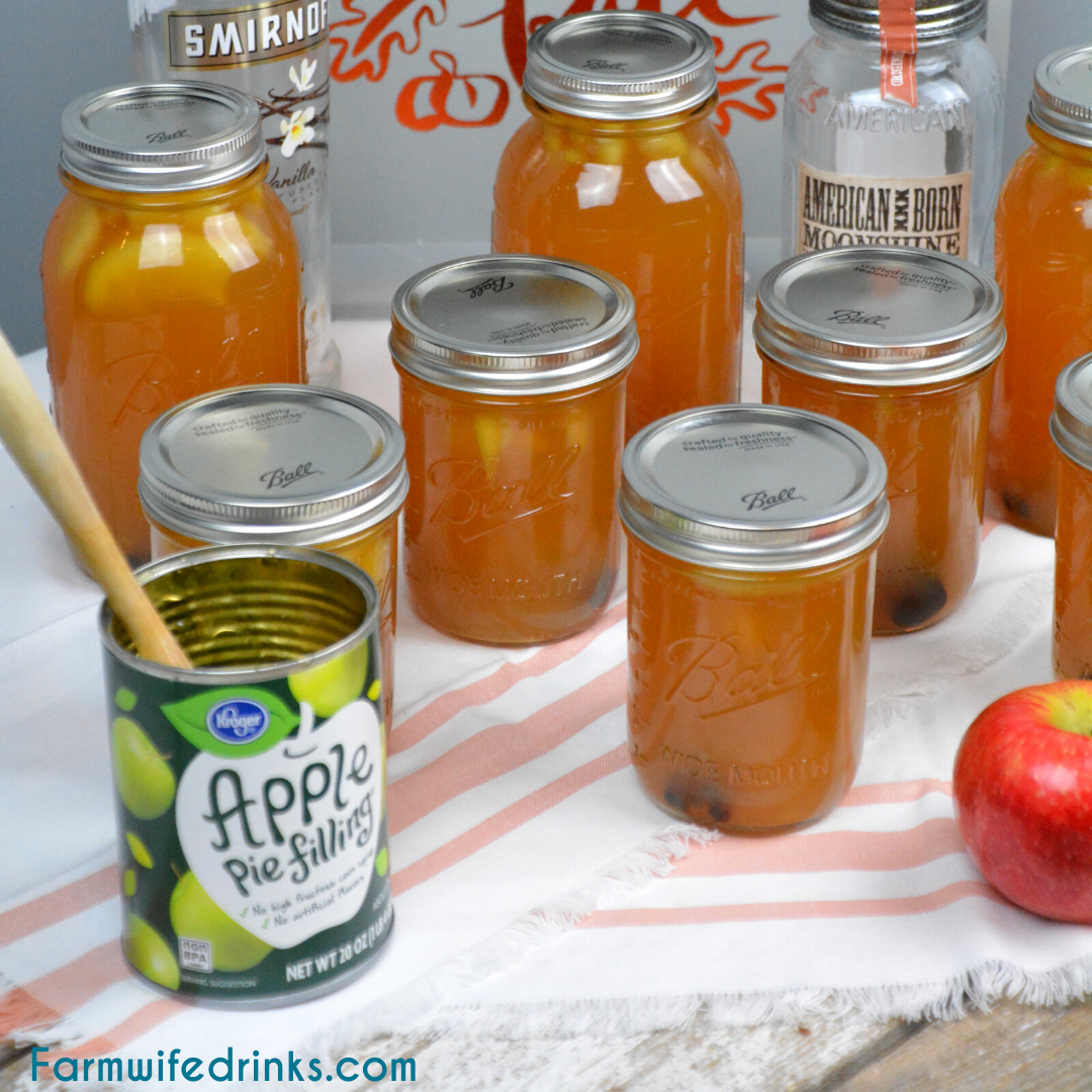 Apple pie moonshine combines apple cider and juice with apple pie filling with cinnamon sticks and vanilla with moonshine and vanilla vodka to create your new favorite fall liquor to drink.