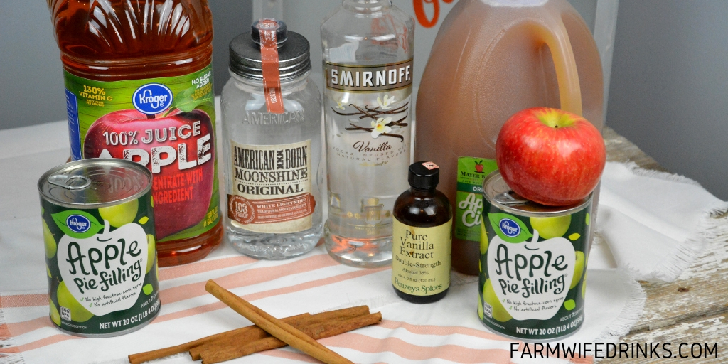 Apple pie moonshine combines apple cider and juice with apple pie filling with cinnamon sticks and vanilla with moonshine and vanilla vodka to create your new favorite fall liquor to drink. #Moonshine #AppleRecipes #ApplePie #Vodka