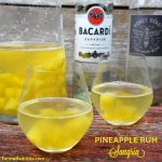 Pineapple Rum Sangria is a crisp white wine sangria combining a dry white wine, rum, frozen pineapple, and sparkling water to make a pitcher of Pineapple Sangria. #Sangria #Rum #Pineapple #Cocktails