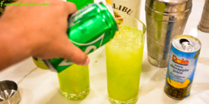 Green Hawaiian Cocktail combines all the tropical flavors of pineapple, melon, coconut, and citrus with Midori, Malibu Rum, pineapple juice, and lemon-lime soda for the best beach or pool cocktail.