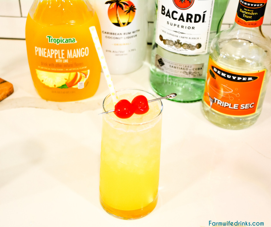 Mango Pineapple Rum Punch combines mango-pineapple juice with triple sec, Malibu rum, and white rum for a smooth Hawaiian rum cocktail that can be topped off with pineapple sparkling water.