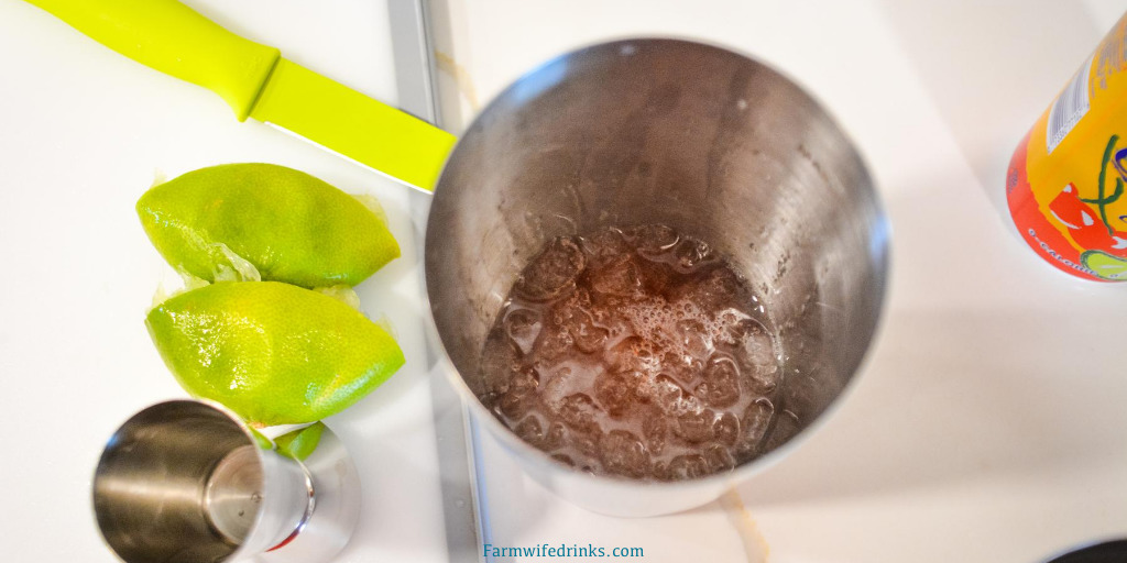 To make the gin rickey, put ice in the cocktail shaker. Then add a shot of gin and the juice of one lime. Shake the gin and lime until the outside of the shaker starts to frost. This is about 20 seconds. The gin and lime juice will be a cloudy clear liquid.