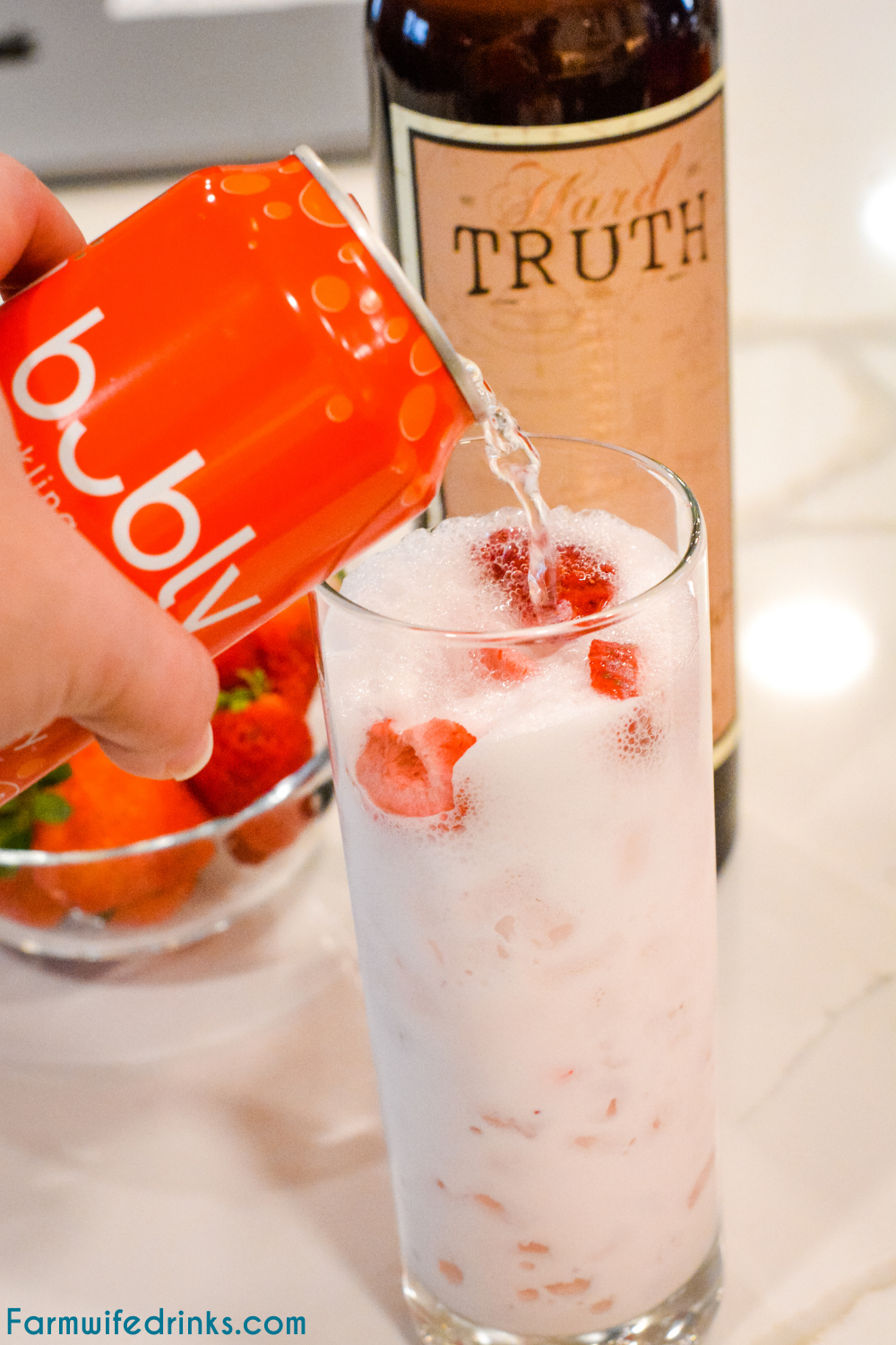 Pink drink cocktail is a yummy toasted coconut rum cream mixed with strawberries and sparkling water to make this delicious strawberry coconut cream rum cocktail.