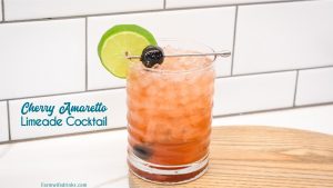 This fruity cocktail is a cherry amaretto limeade cocktail made easily with the combination of amaretto, limeade, and maraschino cherries.