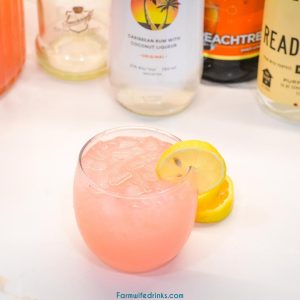 The pink lemonade cocktail known as Island Lemonade is filled with coconut rum, gin, peach schnapps, and vodka and tastes just like the islands.