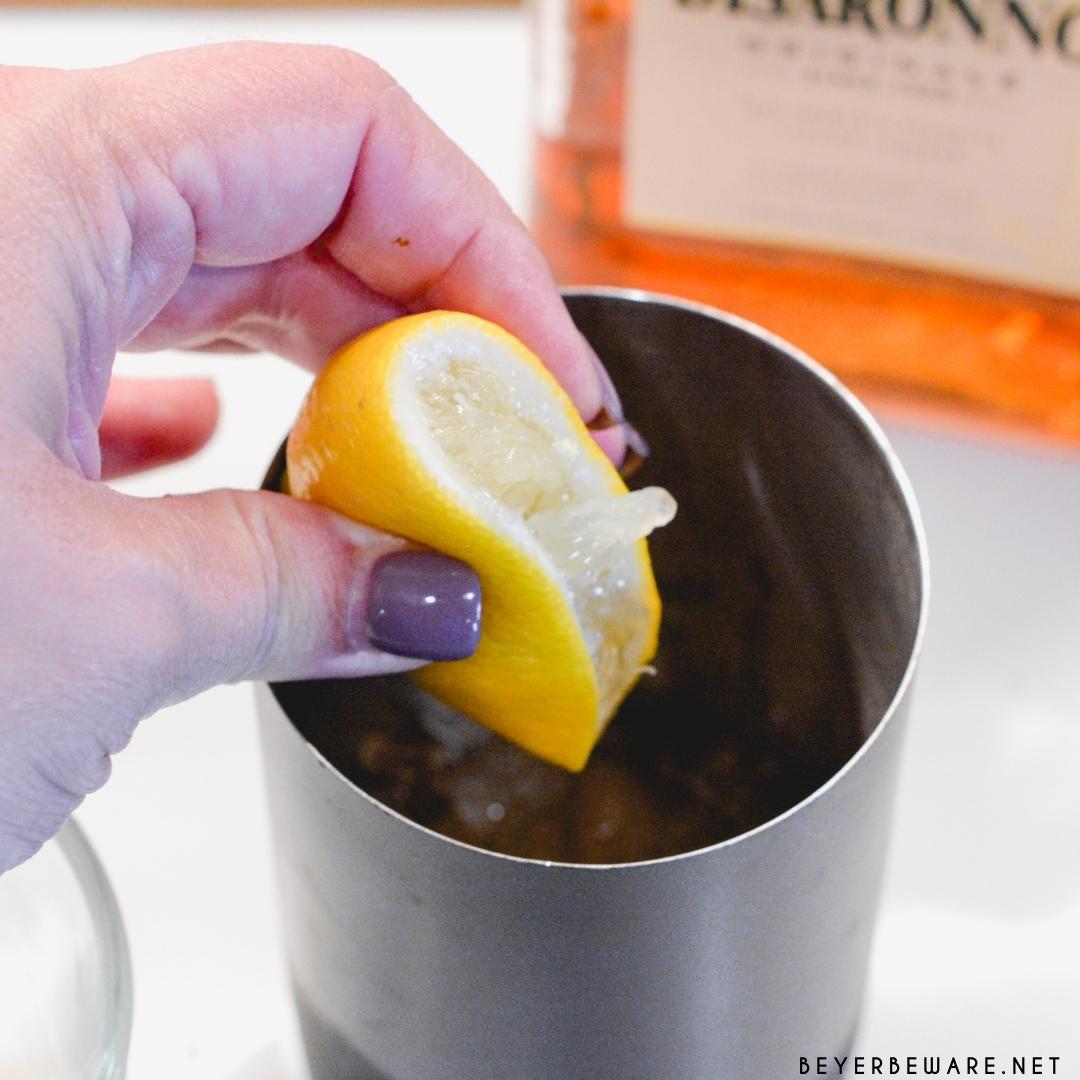 Fill a cocktail mixer with ice. Pour the amaretto, lemon juice, and apple cider over the ice.