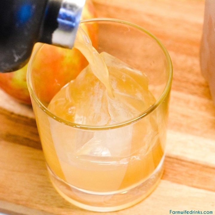 Pour apple cider cocktail over large ice cube in a rocks glass