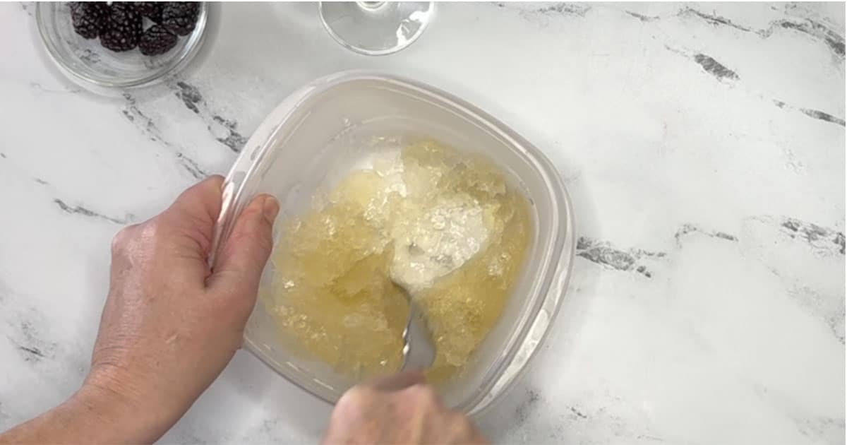 Scrape frozen Champagne with fork, to make Champagne slushy.