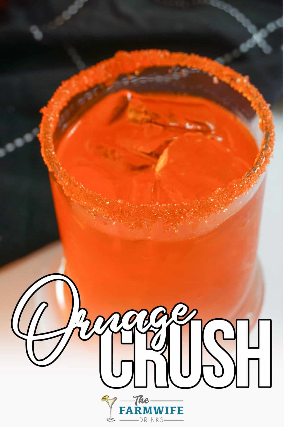 Sleek looking Orange Crush Cocktail with black dish towel.