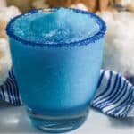 Close up of the Blue sugar rimmed glass of Snowball Punch.