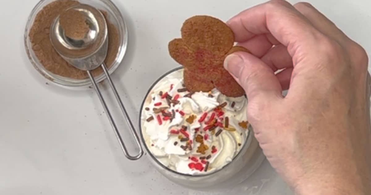 Adding on top of whipped cream the gingerbread cookie