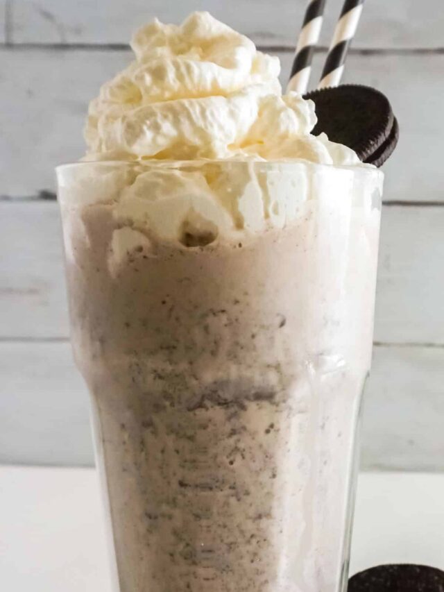 Close up, front view of Oreo Milkshake cookie on rim and table.