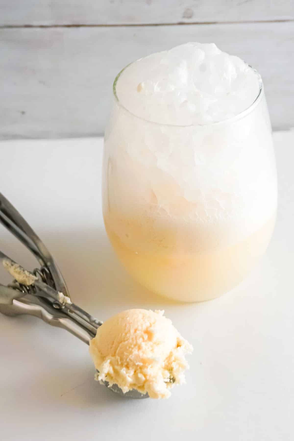 Champagne Ice Cream Float with scoop and ice cream.