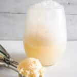 Champagne Ice Cream Float with scoop of vanilla ice cream in front.