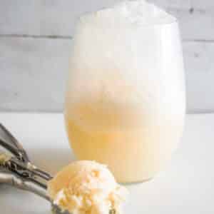 Champagne Ice Cream Float with scoop of vanilla ice cream in front.