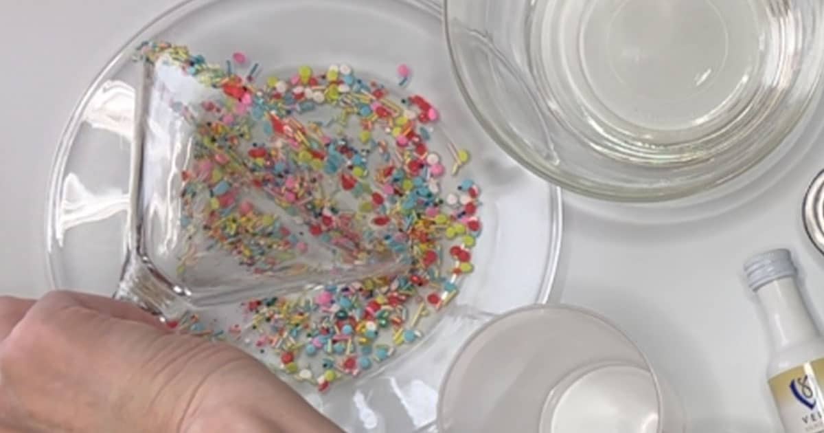 Dipping rim into sprinkles for Sugar Cookie Cocktail.