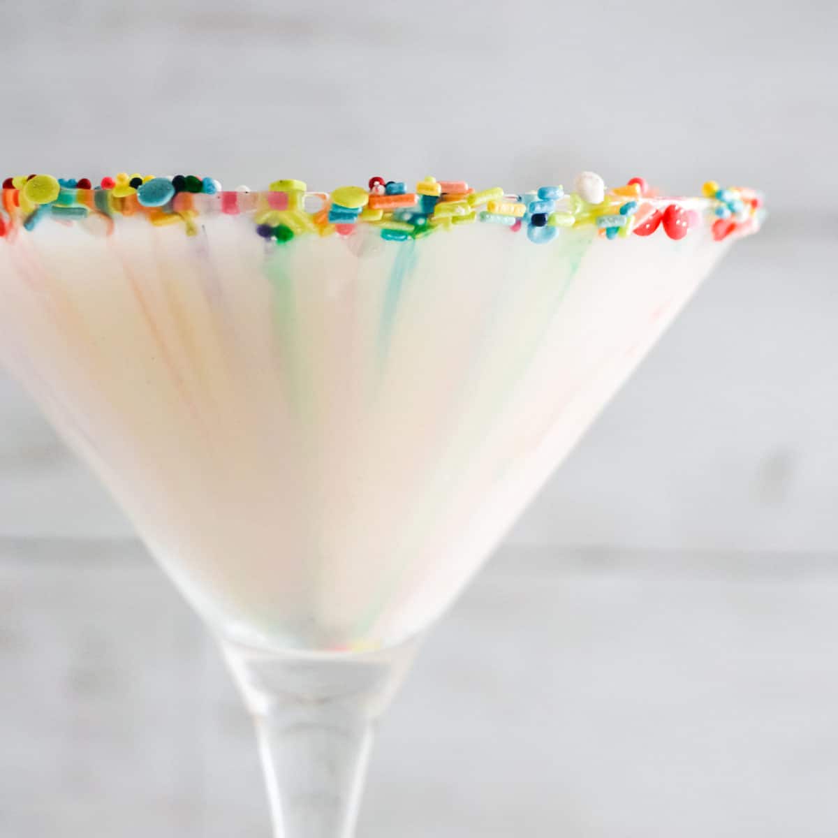 Side view of Sugar Cookie Cocktail, colors bleeding in drink.