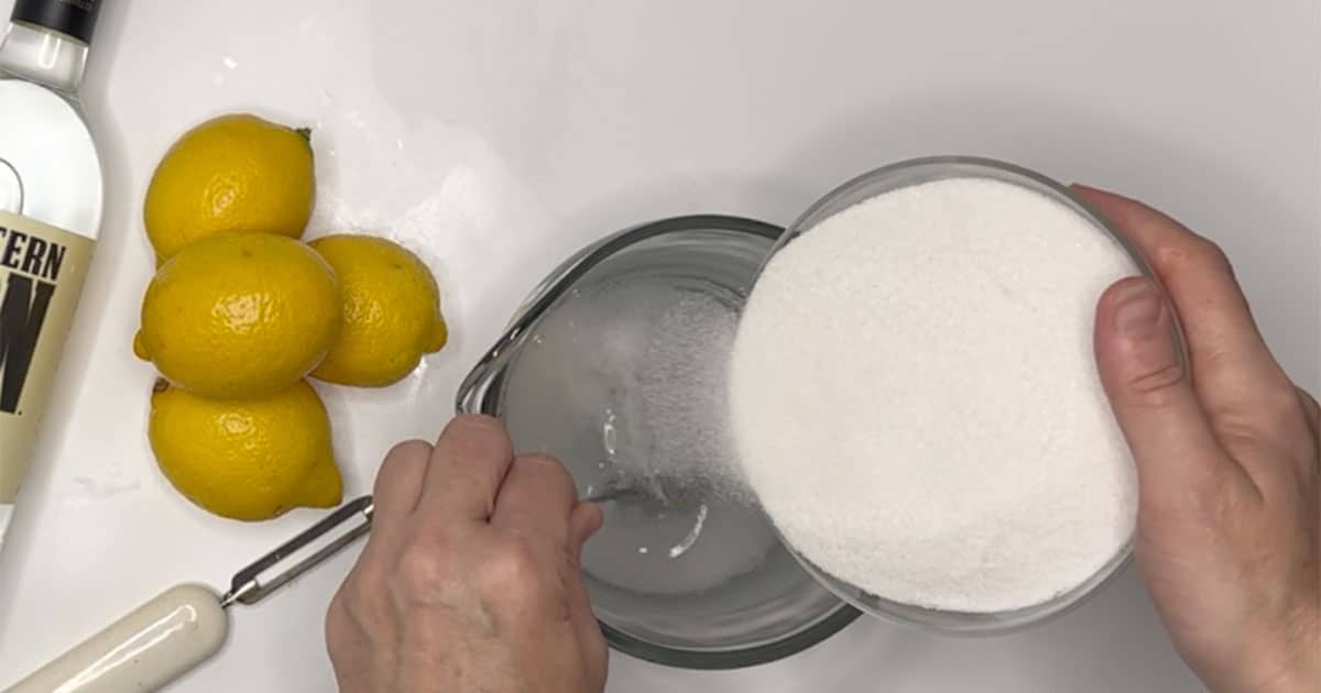 sugar and water being combined to make limoncello