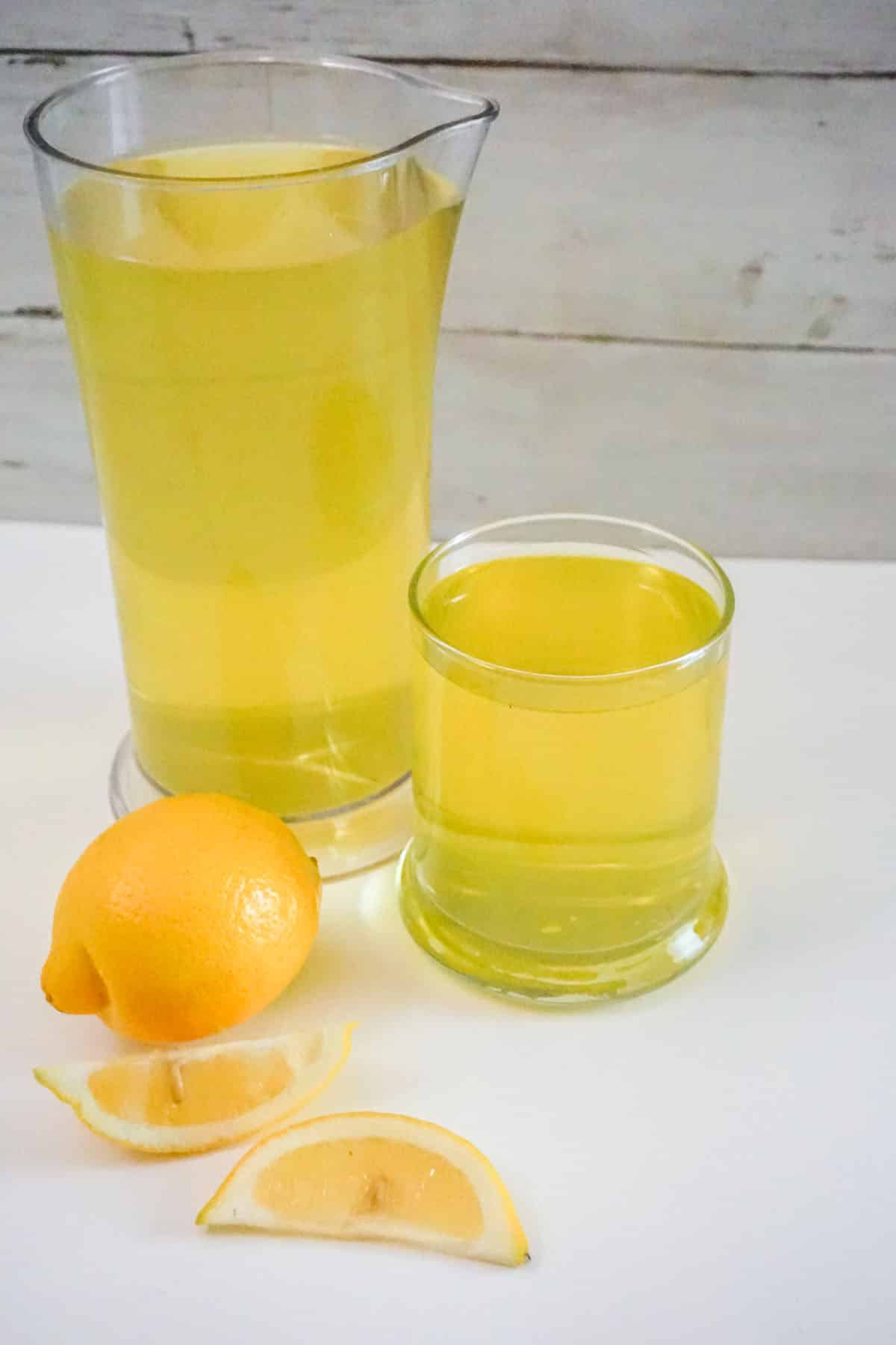 glass and pitcher of homemade limoncello