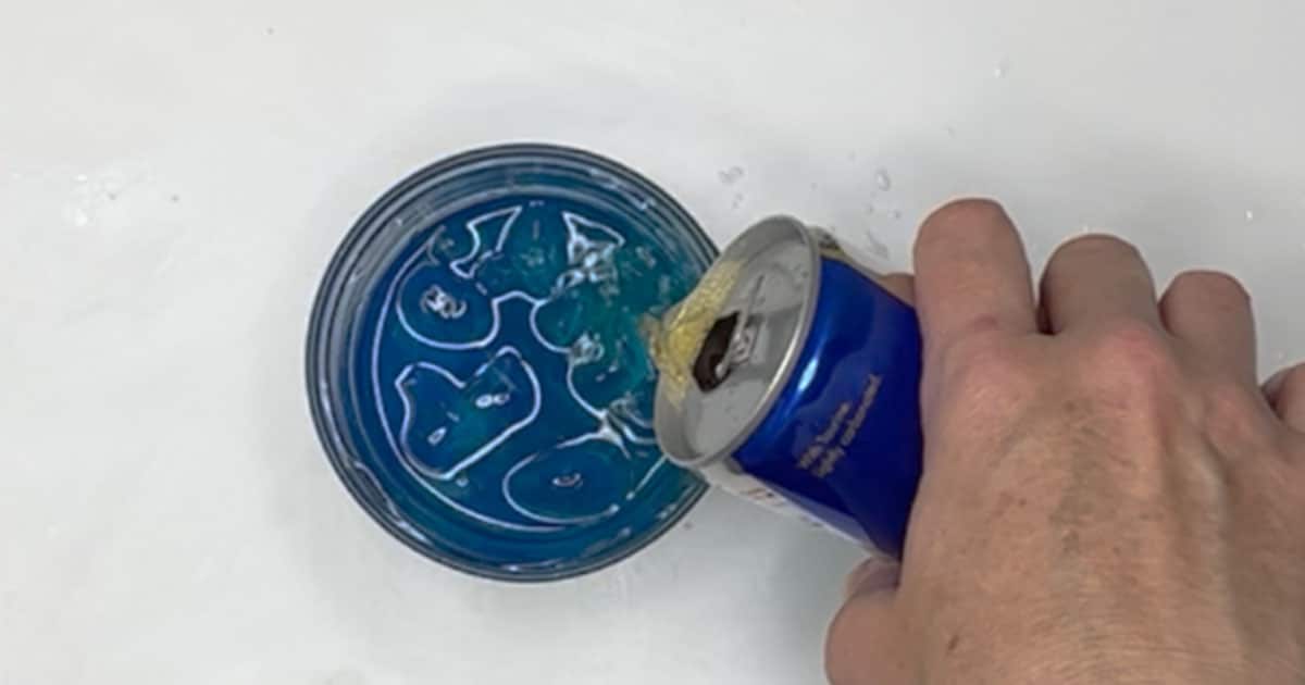 red bull being poured into a glass to make a irish trash can shot